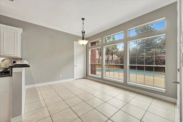 unfurnished dining area with light tile patterned floors and crown molding