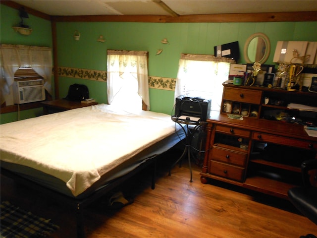 bedroom with hardwood / wood-style flooring and cooling unit