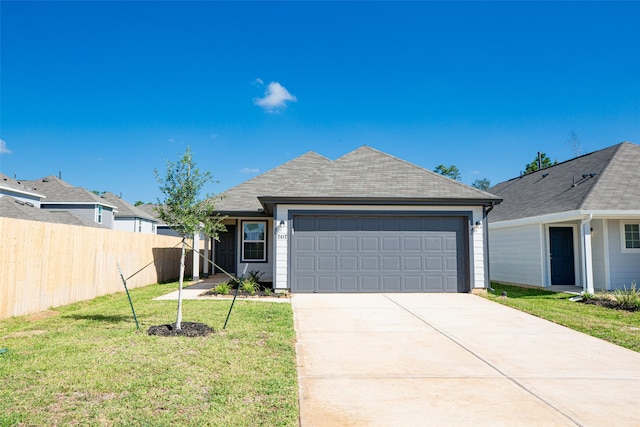 ranch-style home featuring a garage and a front lawn