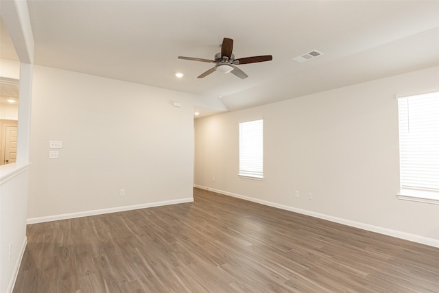 spare room featuring ceiling fan and dark hardwood / wood-style flooring