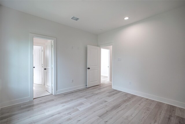 unfurnished room with light hardwood / wood-style floors