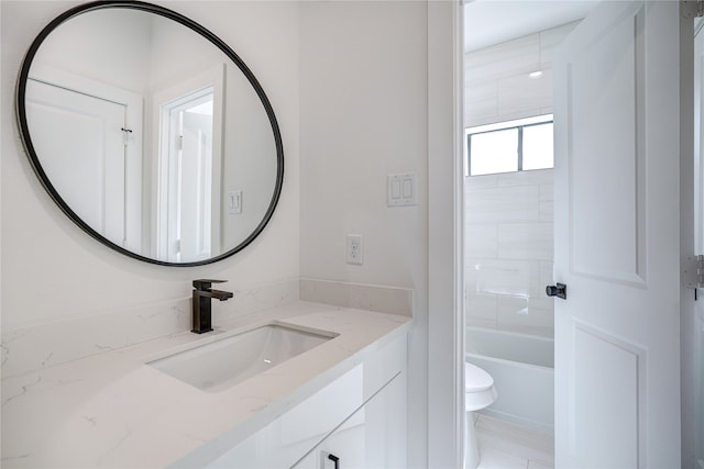 full bathroom featuring tiled shower / bath combo, toilet, and vanity