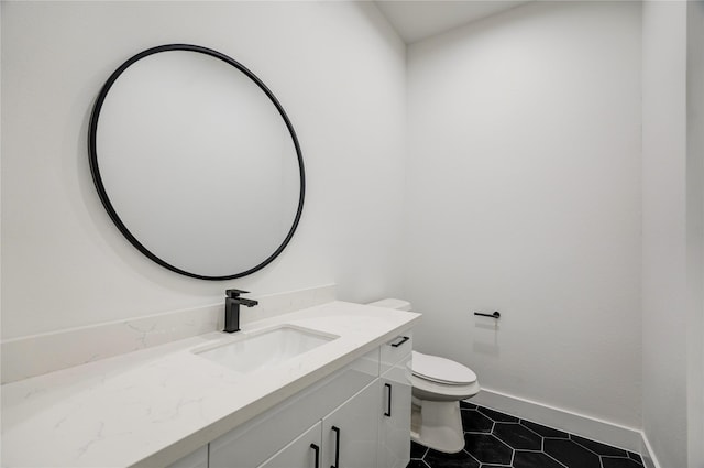 bathroom featuring vanity, toilet, and tile patterned flooring