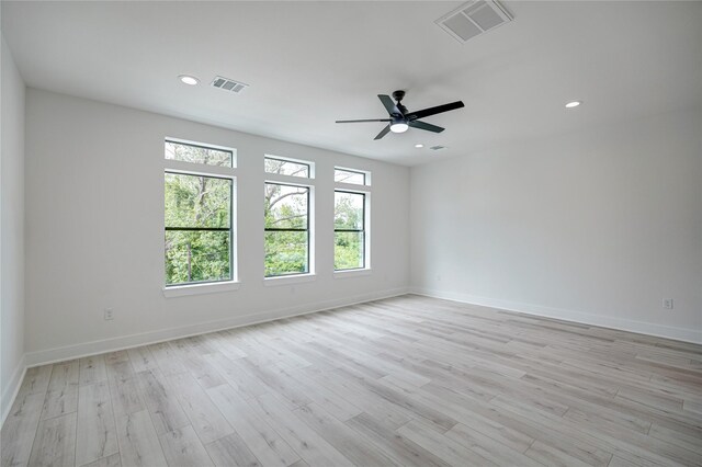 empty room with ceiling fan and light hardwood / wood-style flooring