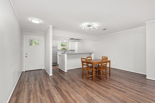 dining area with crown molding and wood-type flooring