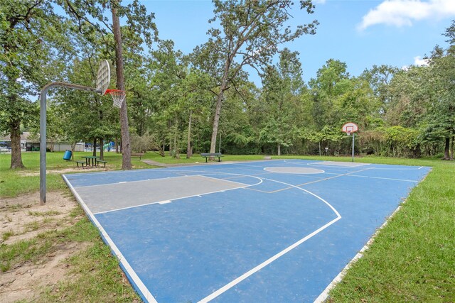 view of basketball court featuring a lawn