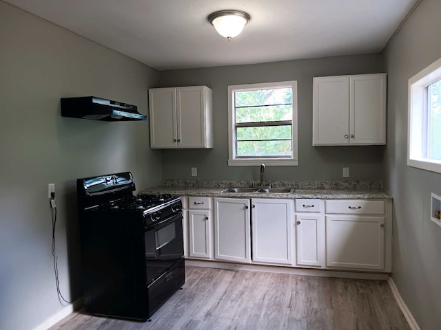 kitchen with black range with gas cooktop, sink, white cabinetry, and ventilation hood