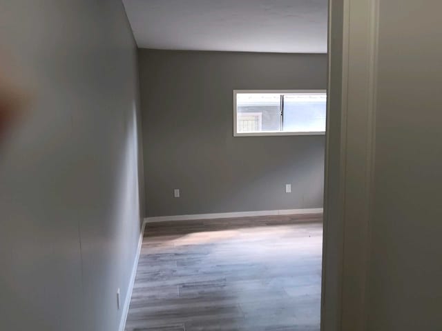 empty room with wood-type flooring