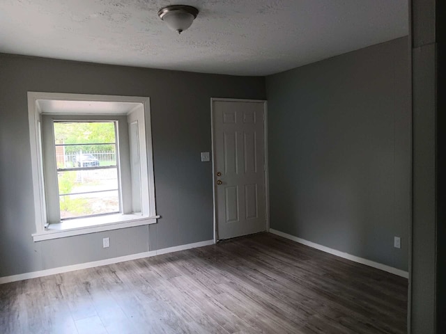 entryway with wood-type flooring and a textured ceiling