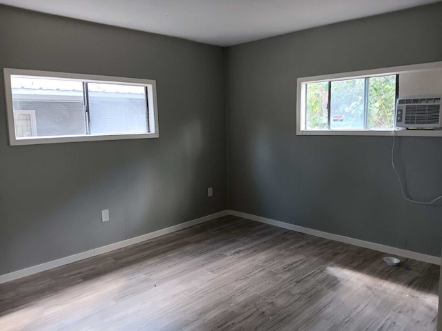 unfurnished room with wood-type flooring