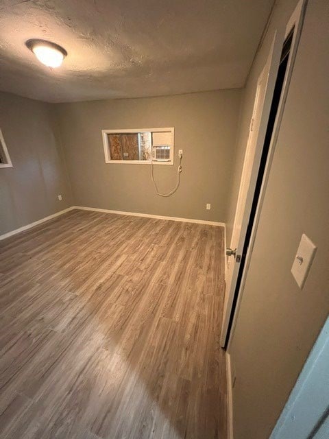 empty room featuring hardwood / wood-style floors and a textured ceiling