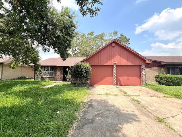 ranch-style home with a garage and a front lawn