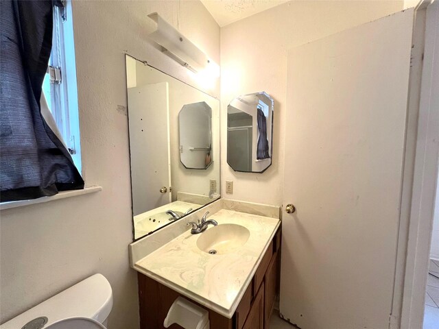 bathroom featuring toilet and vanity