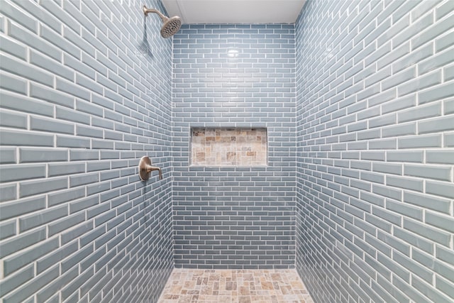 bathroom with a tile shower