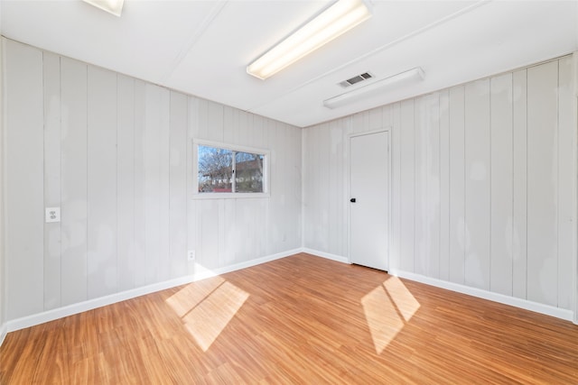 spare room with hardwood / wood-style floors