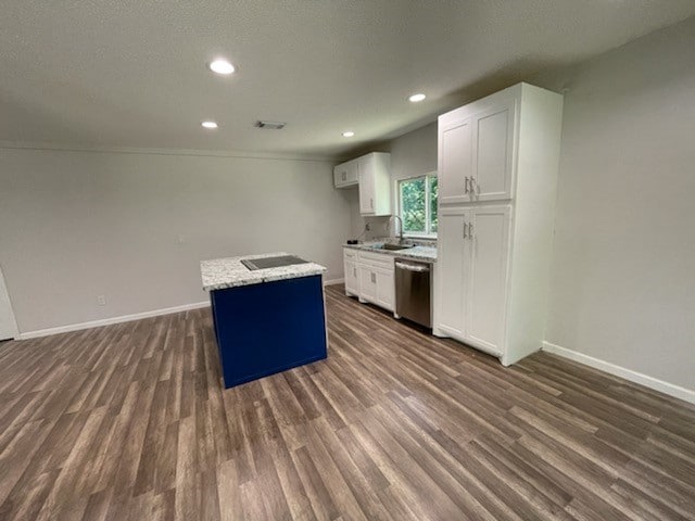 kitchen featuring dark hardwood / wood-style flooring, dishwasher, white cabinetry, and light stone counters