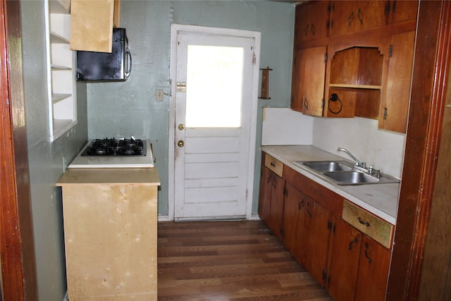 kitchen featuring stainless steel gas cooktop, sink, and dark hardwood / wood-style floors