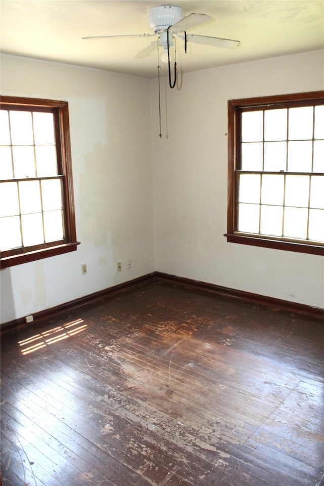 empty room with ceiling fan and wood-type flooring