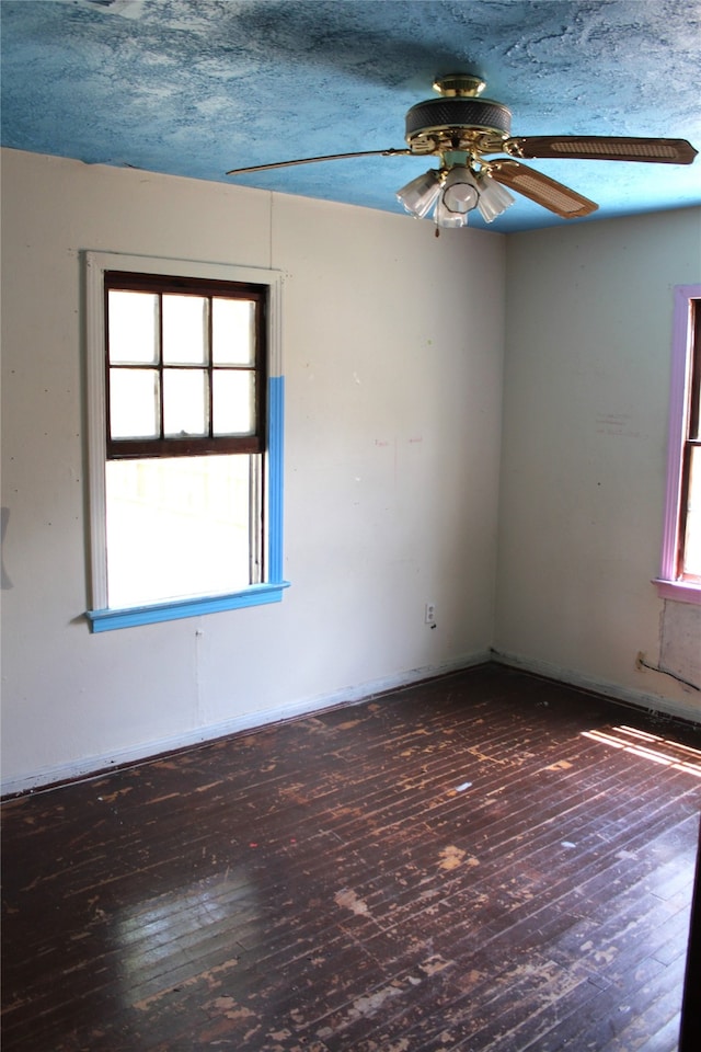 unfurnished room with a textured ceiling, ceiling fan, and hardwood / wood-style flooring