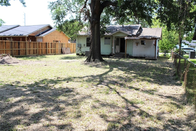 rear view of property with a yard