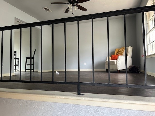 interior space with ceiling fan and wood-type flooring