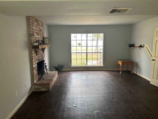 unfurnished living room with a fireplace and dark hardwood / wood-style flooring