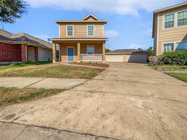 view of front facade with a garage, an outdoor structure, a front yard, and covered porch