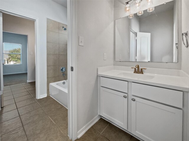 bathroom with vanity, tile patterned flooring, and tiled shower / bath combo