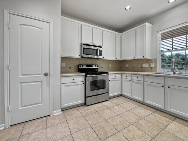 kitchen with white cabinetry, sink, and appliances with stainless steel finishes