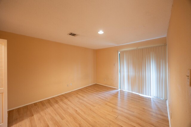 spare room featuring light hardwood / wood-style flooring