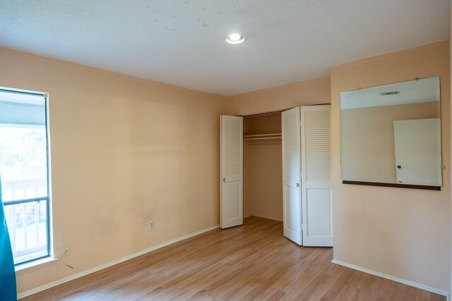 unfurnished bedroom featuring light wood-type flooring