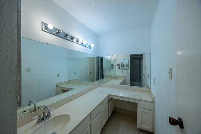 bathroom with vanity, a textured ceiling, and tile patterned floors