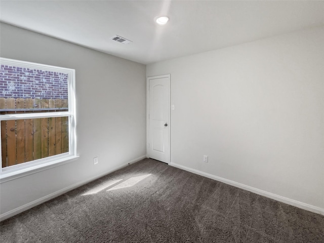 carpeted spare room featuring a healthy amount of sunlight