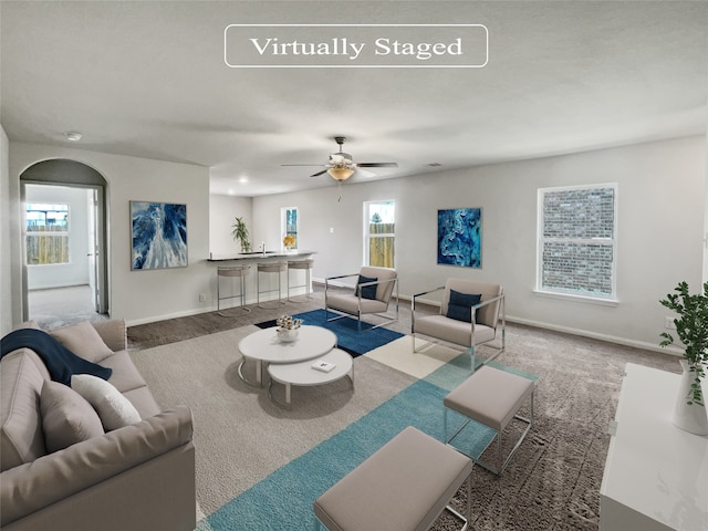 living room featuring ceiling fan and light colored carpet