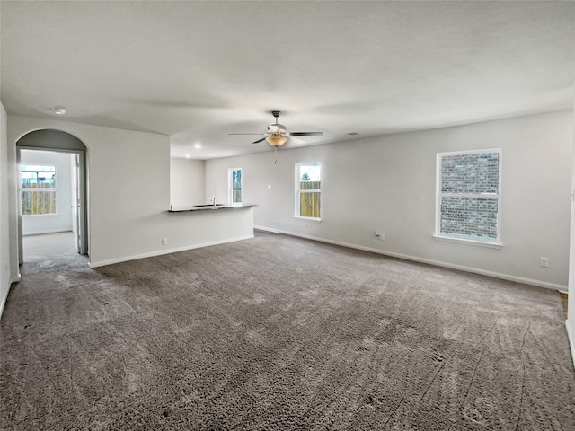 empty room with ceiling fan and carpet flooring