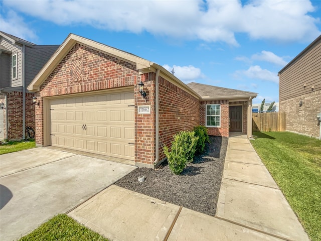 view of front of property with a garage and a front yard