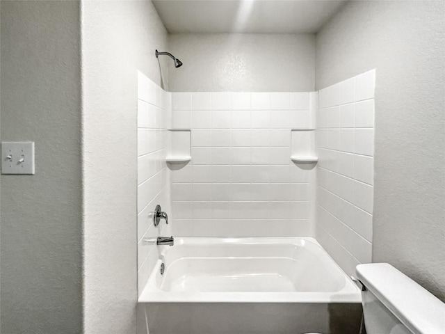 bathroom featuring shower / bathing tub combination and toilet