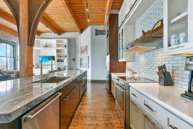 kitchen featuring white cabinetry, sink, appliances with stainless steel finishes, and beamed ceiling