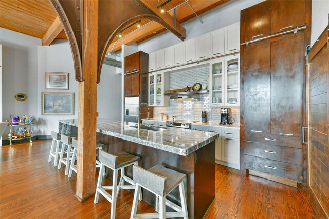 kitchen featuring white cabinetry, sink, a breakfast bar area, and a center island