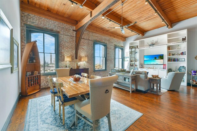 dining space with hardwood / wood-style floors, wooden ceiling, rail lighting, and brick wall