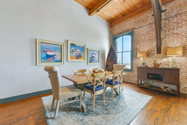 dining room with brick wall, a high ceiling, wooden ceiling, dark wood-type flooring, and beamed ceiling