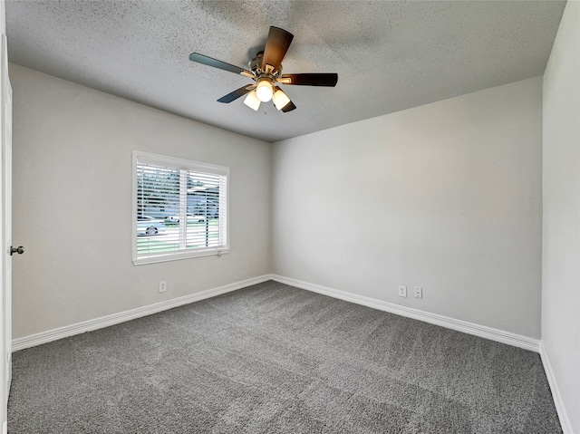 carpeted spare room featuring a textured ceiling and ceiling fan