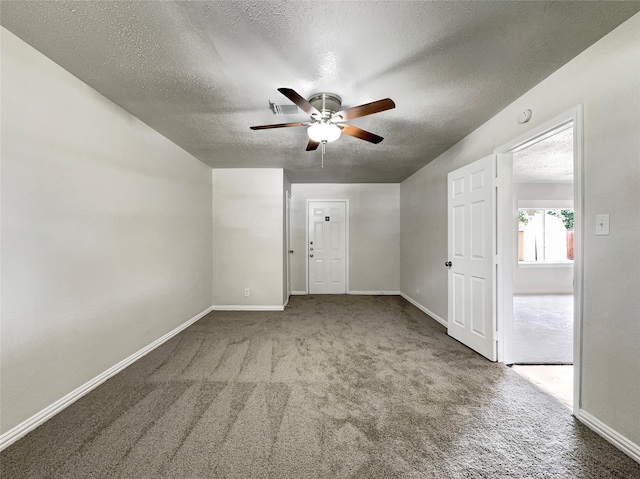 spare room featuring carpet floors, a textured ceiling, and ceiling fan