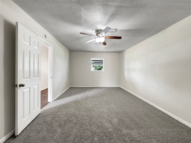 spare room with carpet, ceiling fan, and a textured ceiling