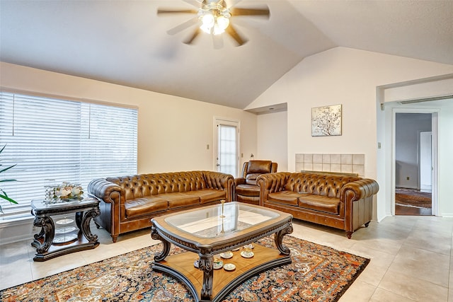 living room featuring a healthy amount of sunlight, ceiling fan, vaulted ceiling, and light tile patterned floors