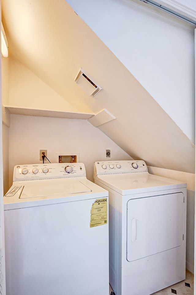 clothes washing area with tile patterned flooring and washer and clothes dryer