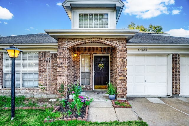 view of exterior entry with a garage