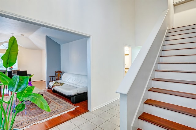 staircase with light tile patterned floors