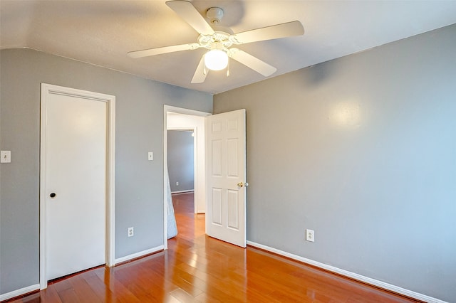 unfurnished bedroom featuring vaulted ceiling, ceiling fan, and hardwood / wood-style floors