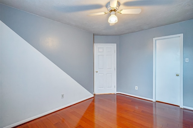 empty room featuring ceiling fan and wood-type flooring